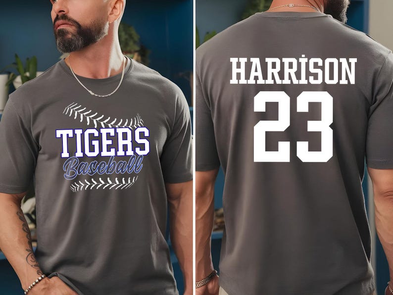 May include: Gray baseball t-shirt with "TIGERS Baseball" text on the front and "HARRISON 23" on the back. The front design includes a baseball graphic. The shirt is short-sleeved.