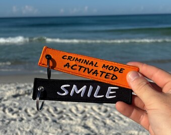 Criminal Mode Activated Jet Tag – Orange Embroidered Keychain, Biker EDC