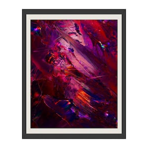 May include: Abstract art print in a black frame. The artwork features a dynamic composition of brushstrokes in shades of red, purple, and orange. The colors blend and overlap, creating a sense of depth and movement. The piece is a modern wall decor.