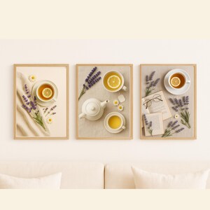 May include: Three framed art prints featuring tea-themed still life arrangements. Each print showcases a cup of tea with a lemon slice, lavender sprigs, and other decorative elements. The frames are light-colored wood.