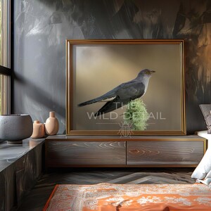 May include: A framed print of a bird perched on a mossy branch. The bird has grey and white feathers, with a yellow beak. The print is in a gold frame, displayed on a wooden cabinet. The text "THE WILD DETAIL" is visible on the print.