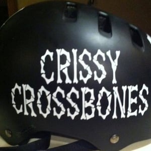 May include: Black helmet with white lettering that reads "Crissy Crossbones".