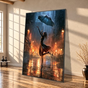 May include: A framed wall art print depicting a person in a dark dress holding a blue umbrella while dancing in a rain-slicked city street at night, illuminated by warm orange streetlights and reflections on the wet ground.