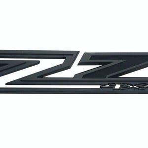 May include: Black Z71 4x4 emblem. The emblem features the letters "Z71" in a bold, angular font, with "4x4" below. The emblem is a matte black color and is likely made of plastic or metal.