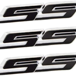 May include: Three chrome and black SS emblems. Each emblem features a stylized "SS" design with a glossy black centre and a shiny chrome border. The emblems are designed to be affixed to a vehicle.