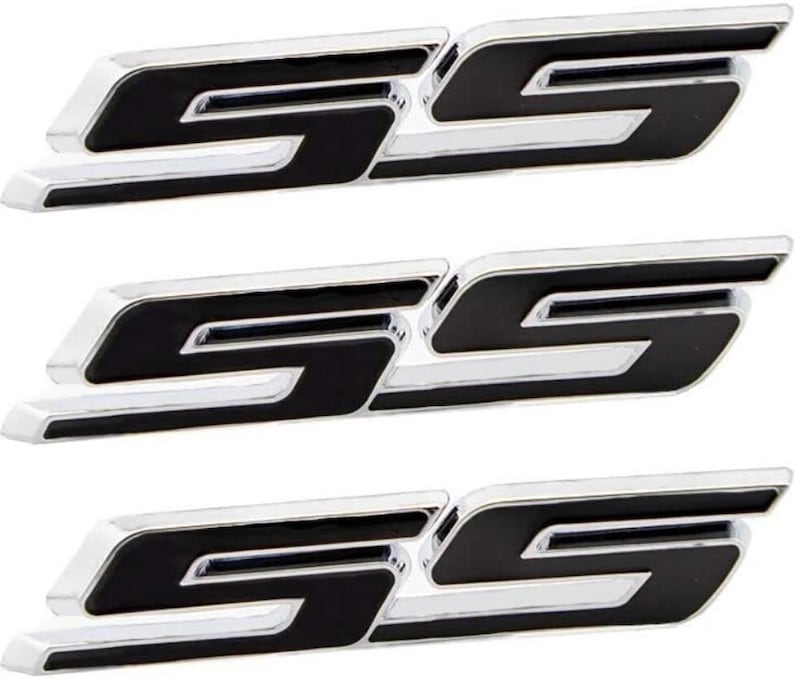 May include: Three chrome and black SS emblems. Each emblem features a stylized "SS" design with a glossy black centre and a shiny chrome border. The emblems are designed to be affixed to a vehicle.