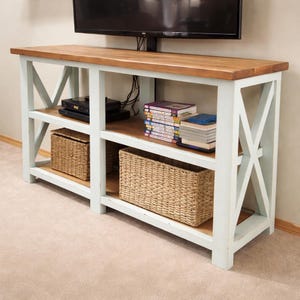 May include: A set of three ceramic vases in varying heights. The vases are white with a textured, ribbed design. The tallest vase is approximately 10 inches tall, the medium vase is 8 inches, and the smallest is 6 inches.