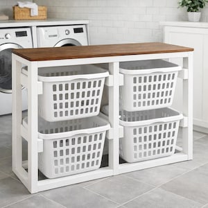 May include: A white laundry sorter with a dark brown wooden top. The sorter has four white plastic laundry baskets. The frame is white and the unit is designed for a laundry room.