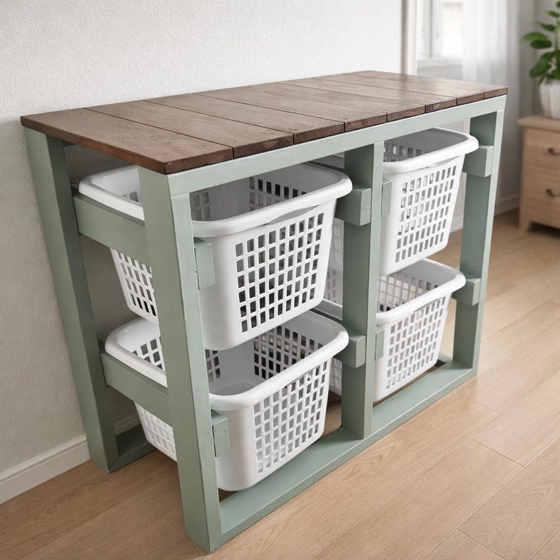 May include: A wooden laundry sorter with a brown tabletop and a light green frame. It features four white plastic laundry baskets. The sorter is designed for organizing laundry and has a simple, functional design.