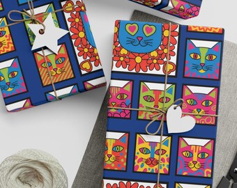 May include: Several gift-wrapped presents with patterned paper featuring colourful cat faces. The paper has a dark blue background. Each gift is tied with twine and a decorative tag. Scissors and string are also visible.