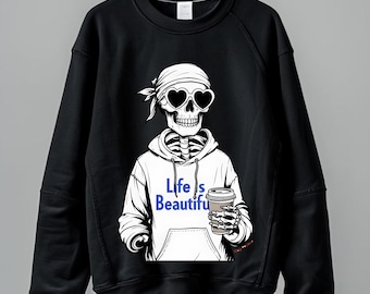 May include: Black sweatshirt featuring a skeleton wearing heart-shaped sunglasses and a white hoodie. The hoodie has the text "Life is Beautiful" in blue. The skeleton is holding a coffee cup. The design is a graphic illustration.