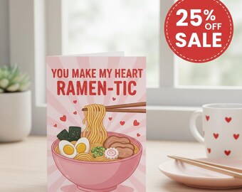 May include: A pink greeting card with the text "YOU MAKE MY HEART RAMEN-TIC" and a cartoon ramen bowl. The card has a light pink striped background and small red hearts. A red circle with "25% OFF SALE" is visible in the image.