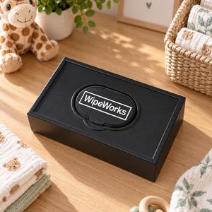 May include: A rectangular black plastic wipe dispenser box featuring a central lid with the white text WipeWorks printed inside a rectangular border. The container has a smooth matte finish and a hinged opening mechanism for accessing wipes.
