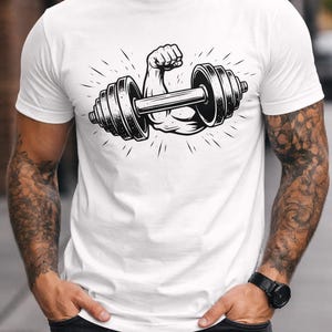 May include: White t-shirt featuring a black and white illustration of a muscular arm flexing while holding a dumbbell. The design includes radiating lines, suggesting power and strength. The shirt is plain and has short sleeves.