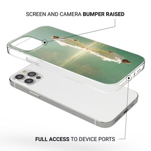May include: Clear phone case with a printed image of a person in white clothing on a green background. The case has a raised bumper for the screen and camera, and provides full access to device ports.
