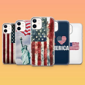 May include: A collection of phone cases featuring patriotic designs. The cases display the American flag, the Statue of Liberty, and the word "America" with a heart-shaped flag. The cases are clear with colorful graphics.
