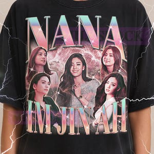 May include: Black t-shirt featuring the text "NANA IMJINAH" in a gradient font, with images of six women. The Milkshack logo is at the top. The shirt is a unisex style.