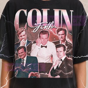 May include: Black t-shirt featuring a collage of Colin Firth images with the name "COLIN Firth" in a pink and white retro design. The Milkshake logo is at the top.