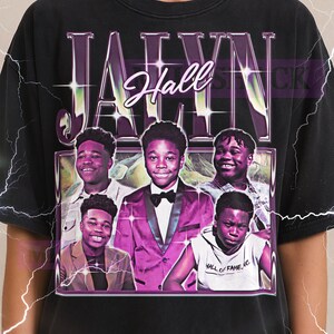 May include: Black unisex t-shirt featuring a graphic of the name "Jahyn Hall" in a stylized font, with images of several young men. The shirt also includes the text "Hall of Fame, Inc."