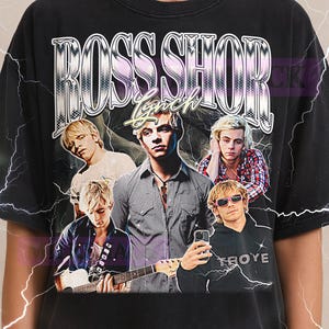 May include: Black t-shirt featuring a graphic of Ross Shor Lynch with the text "ROSS SHOR LYNCH" in a retro style. The shirt has a vintage aesthetic with multiple images of the artist. The Milkshake logo is at the top.