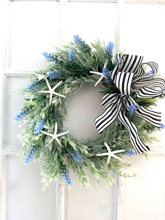 Beach Wreath for all seasons. This coastal beauty has five real starfish set on a weather resistant 12 inch artificial seagrass wreath.