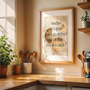 May include: A wooden-framed print with a quote by Alan Turing is displayed above a kitchen counter. The quote reads, "Sometimes it is the people no one imagines anything of who do the things that no one can imagine." There are also plants and utensils.