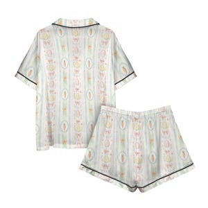 May include: A white ceramic mug with a black handle and the text "But First, Coffee" in a handwritten style. The mug is on a white surface. The mug is 4 inches tall.