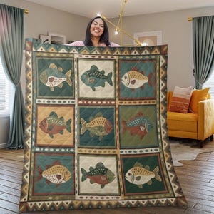 May include: A quilted blanket featuring a repeating pattern of stylized fish in various colors, including green, brown, and white. The fish are set against a patchwork of squares in earthy tones, with a decorative border.
