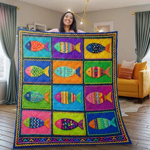 May include: A colorful quilt featuring a repeating pattern of stylized fish in various colors. Each fish is set within a square, with a blue border and a decorative yellow trim. The quilt is displayed in a well-lit room.
