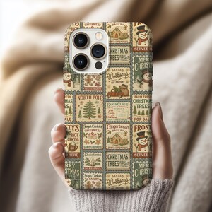 May include: A phone case with a festive Christmas theme. The case features a collage of vintage-style postage stamp designs with images of snowmen, Christmas trees, gingerbread houses, and the text "Christmas Trees For Sale" and "Santa's Workshop".