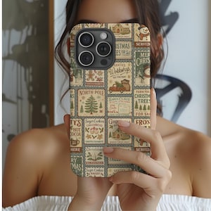 May include: A phone case with a Christmas-themed design. The case features a collage of vintage-style postage stamps with holiday imagery, including a Christmas tree, snowman, and text like "Santa's Workshop" and "Christmas Trees for Sale."