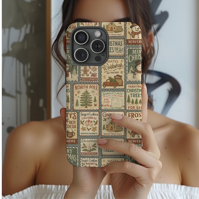 May include: A phone case with a Christmas-themed design. The case features a collage of vintage-style postage stamps with holiday imagery, including a Christmas tree, snowman, and text like "Santa's Workshop" and "Christmas Trees for Sale."