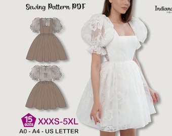 May include: A white dress with a square neckline and sheer, puffy sleeves. The dress features a fitted bodice and a flared skirt. The image also shows a sewing pattern with a brown dress design and the text "Sewing Pattern PDF". The pattern includes sizes XXXS-5XL.