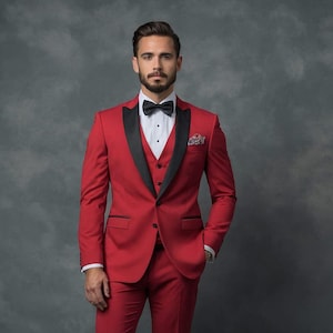May include: A red three-piece suit with black lapels and a black bow tie. The suit includes a jacket, vest, and trousers. A white dress shirt and a patterned pocket square complete the formal attire. The man is standing in front of a gray background.