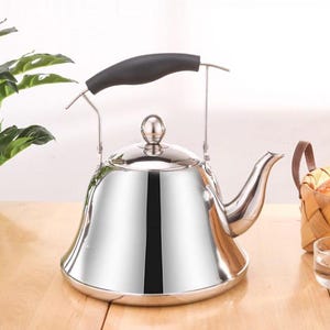May include: A shiny, stainless steel tea kettle with a black handle and a curved spout. The kettle has a rounded body and a small, round lid with a knob. The handle is arched and attached to the kettle with metal supports. A classic kitchenware item.