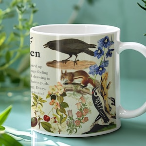 May include: White ceramic mug with a vintage illustration of a crow, squirrel, and woodpecker, alongside flowers and botanical details. The mug has a white handle and the word "en" is visible.