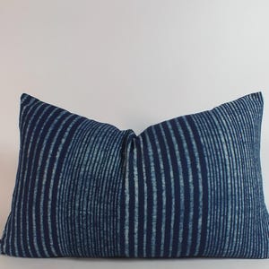 May include: A blue and white striped throw pillow with a subtle, textured pattern. The pillow is made of a soft, comfortable fabric and is perfect for adding a touch of style to any room.