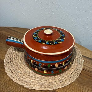 May include: A set of three ceramic mugs with a speckled, matte finish. The mugs are in shades of cream, light gray, and dark gray. Each mug has a simple, minimalist design, perfect for coffee or tea.