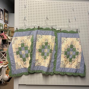 May include: Three rectangular quilted fabric panels featuring a patchwork design with a central green and cream floral block pattern, surrounded by a light blue border and finished with a scalloped green edge trim along the outer perimeter.