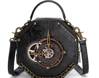 May include: Black, hexagonal handbag with a steampunk clock design. The bag features a top handle, a detachable shoulder strap, and a decorative clock face with visible gears. The bag has a chain detail and brass-colored hardware.