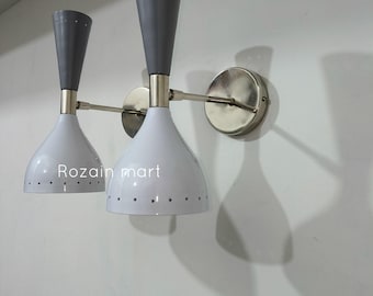 May include: Two wall-mounted sconces with a mid-century modern design. Each sconce features a white, bell-shaped shade with a gray top and a silver arm. The text "Rozain mart" is printed on the shade.
