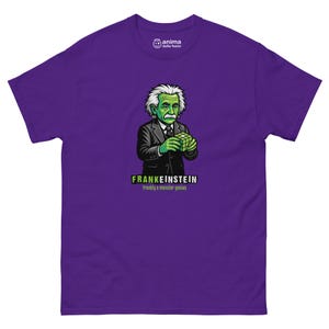 May include: A purple t-shirt with a cartoon image of Frankenstein as Albert Einstein. The illustration depicts Einstein with green skin, white hair, and a black suit, holding a Rubik's Cube. The text "FRANKENSTEIN frankly a monster genius" is below the image.