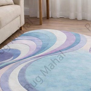 Abstract swirl shaped pastel area rug in blue, purple and white colors styled in a modern living room interior