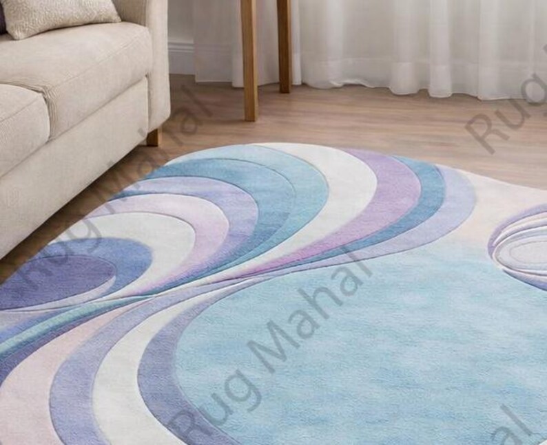 Abstract swirl shaped pastel area rug in blue, purple and white colors styled in a modern living room interior