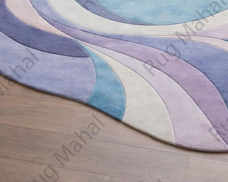 Abstract swirl shaped pastel area rug in blue, purple and white colors styled in a modern living room interior