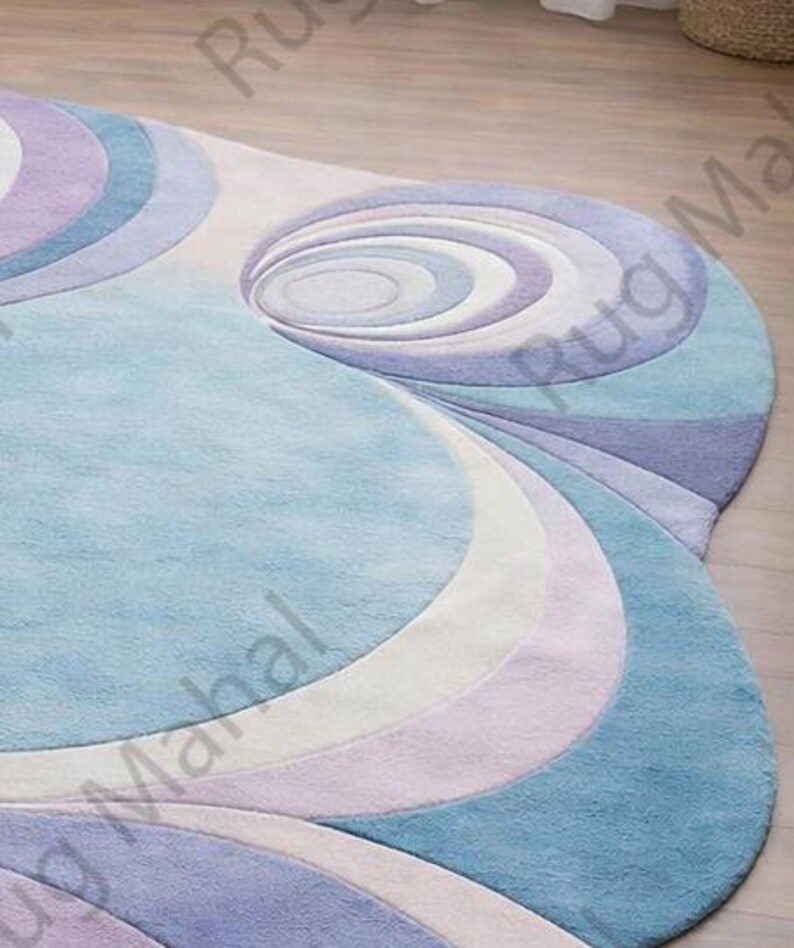 Abstract swirl shaped pastel area rug in blue, purple and white colors styled in a modern living room interior