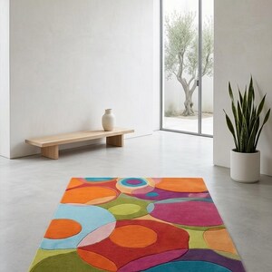 Minimal space featuring vibrant abstract rug as a bold statement piece.
