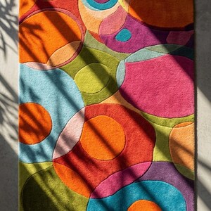 Natural sunlight casting shadows across colorful rug highlighting texture and depth.