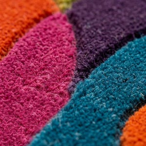 Extreme close-up of dense tufted fibers showing vibrant yarn colors and soft texture.