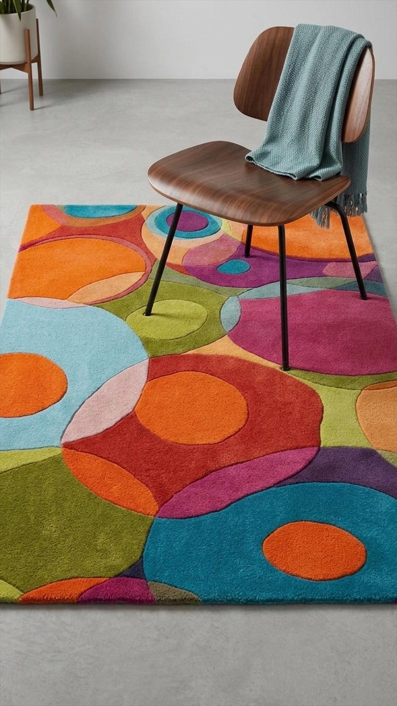 Cozy reading corner with colorful rug under chair and side table.